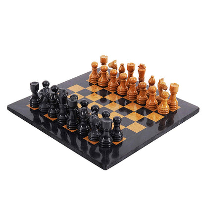 Black and golden marble chess pieces with glossy polished finish