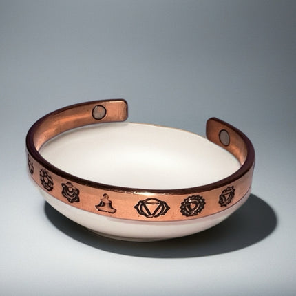 Adjustable open cuff copper bracelet with decorative symbols