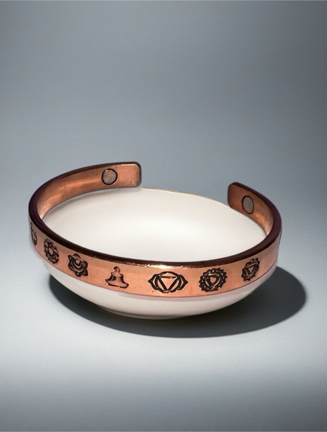 Adjustable open cuff copper bracelet with decorative symbols