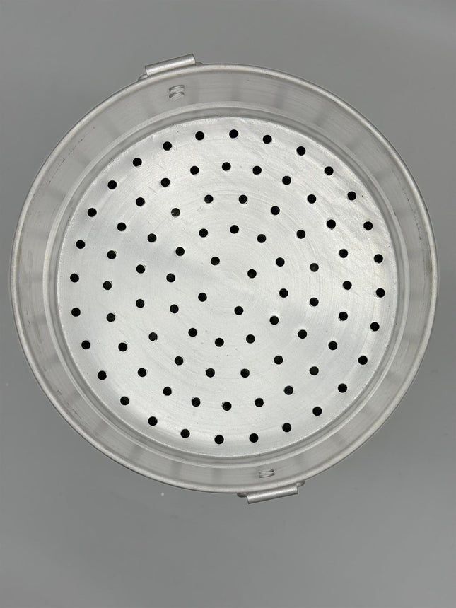 Close up of perforated aluminium momo steaming tray