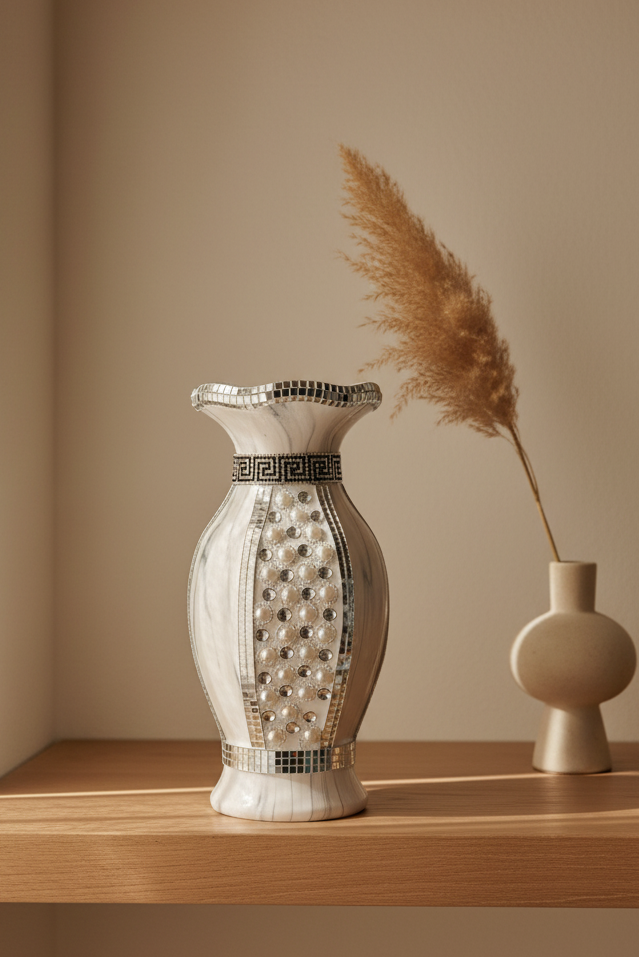Decorative vase with intricate patterns on a wooden shelf against a beige wall